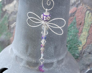 Lightweight wire dragonfly ornament designed for hanging indoor or garden decor